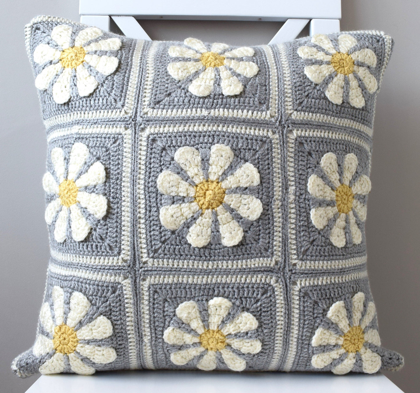 just cushions hand crochet cushions granny squares in grey and white with daisies handmade in the uk